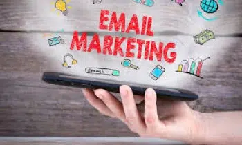 A hand holding a tablet with digital icons representing B2C email marketing, featuring a globe, light bulb, magnifying glass, envelope, and bar chart. The words "Email Marketing" are prominently displayed.